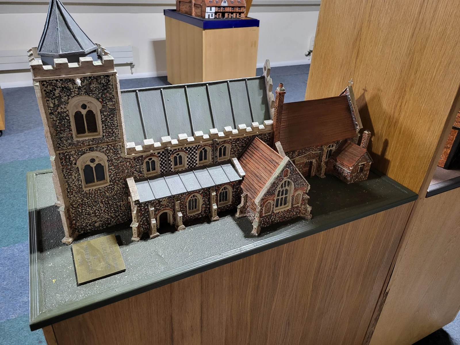 Scale model of a church with a square tower and pitched roofs