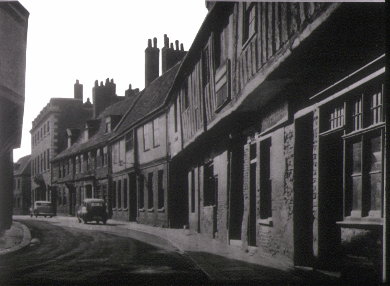 Historic black-and-white view of timber-framed buildings along a street