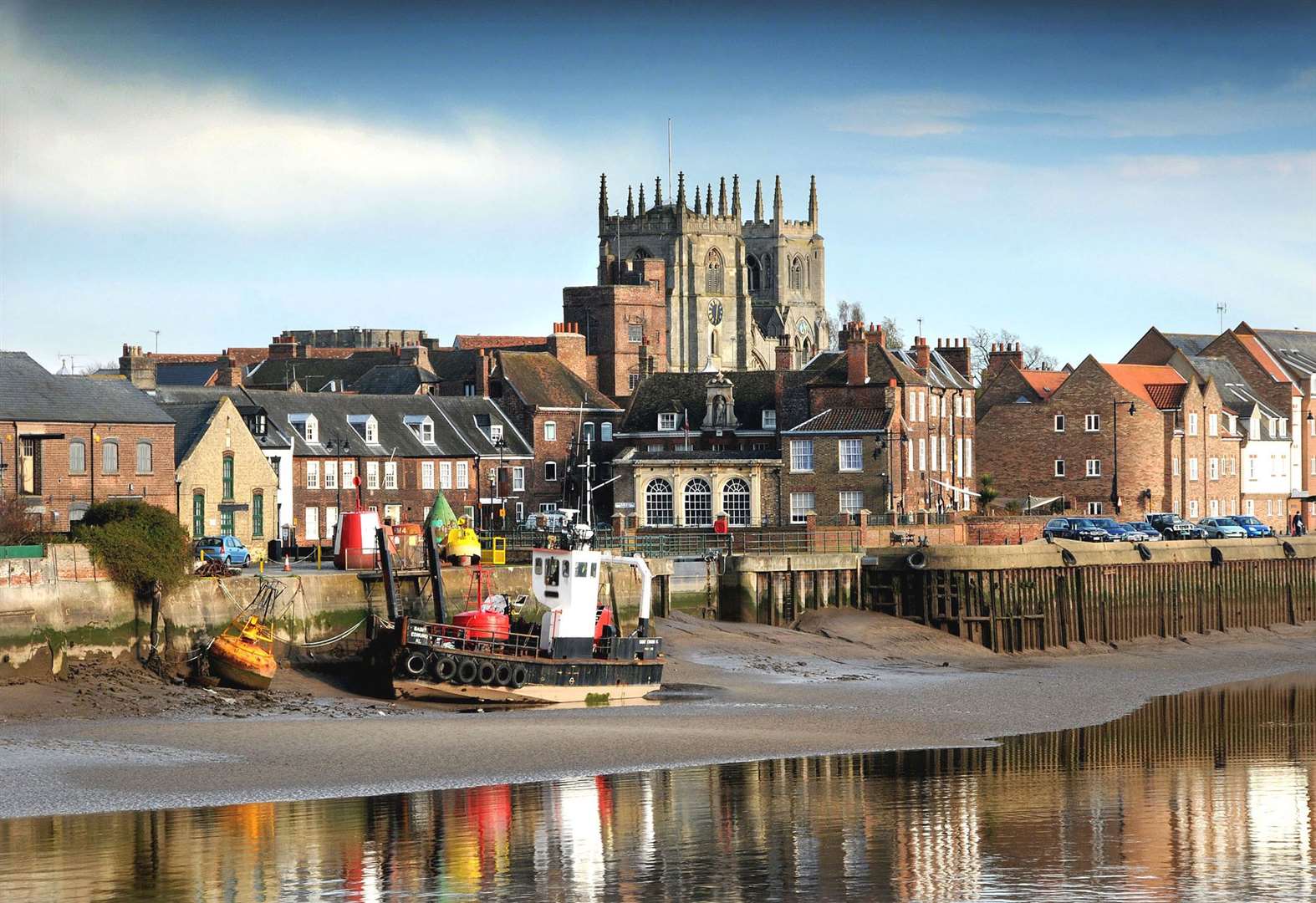 King's Lynn waterfront with church towers and moored boats