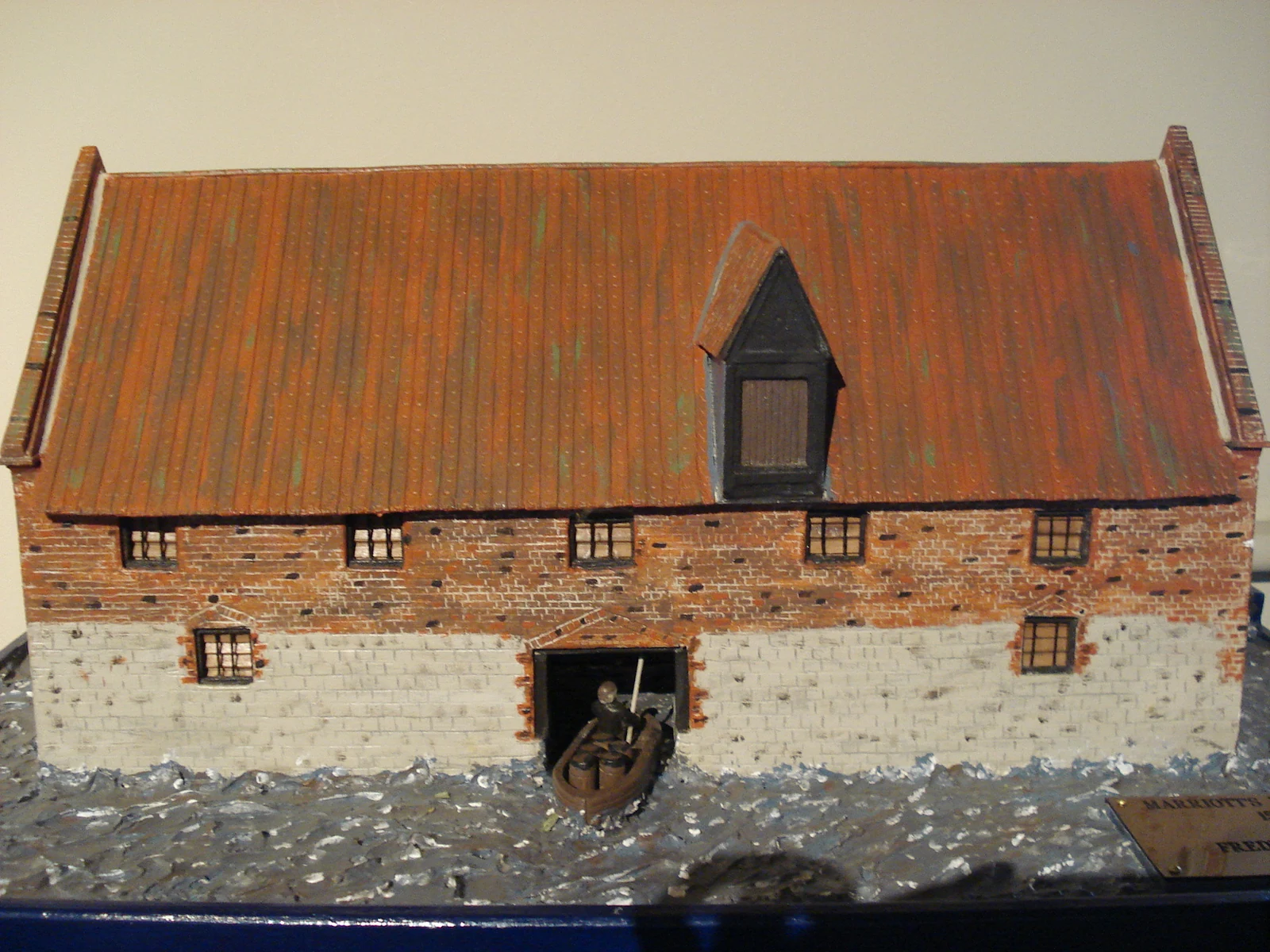 Scale model of Marriott's Warehouse, showing its tiled roof and stone lower walls
